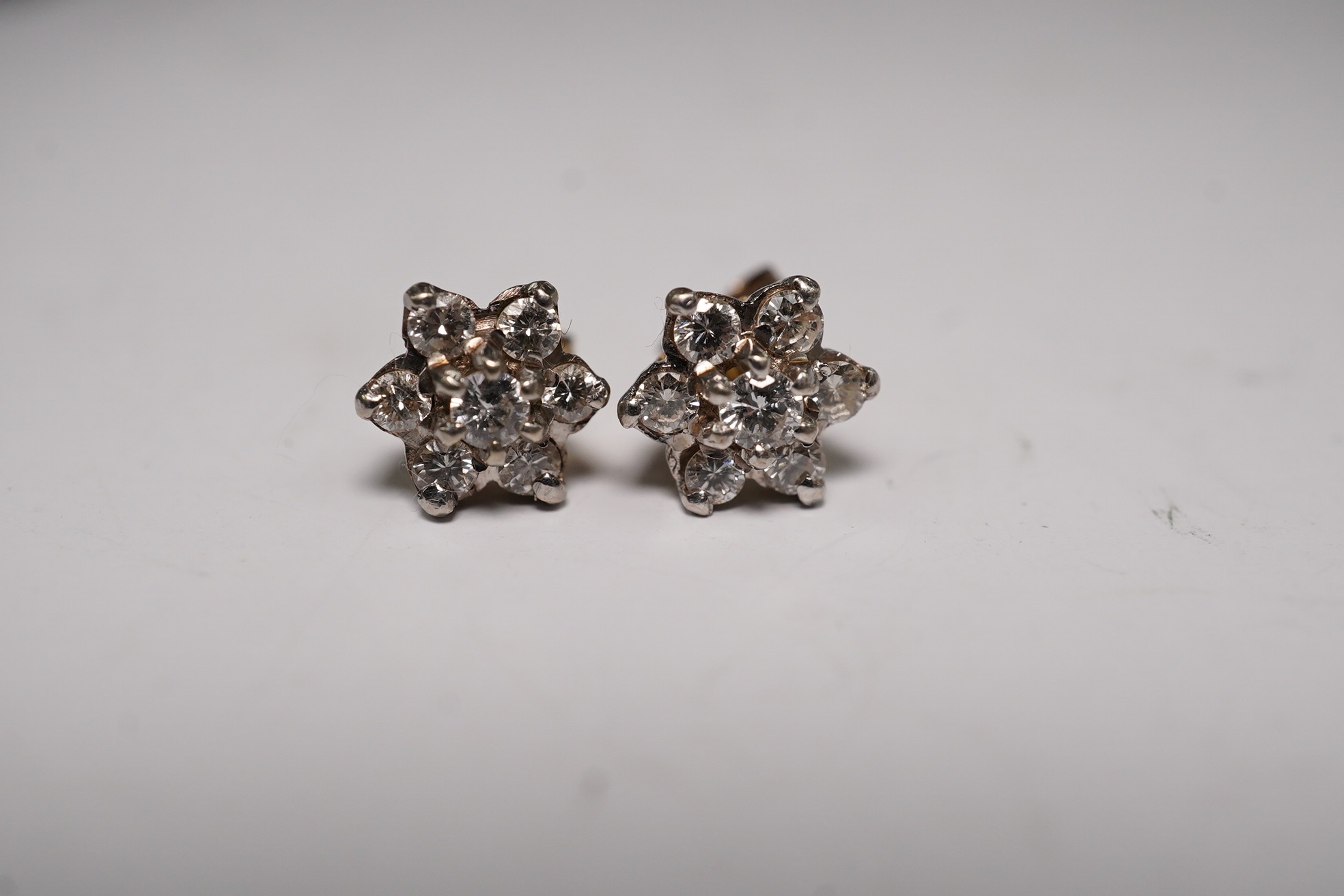 A white metal, diamond and ruby set pendant, 26mm and a pair of 9ct and diamond cluster set ear studs, gross weight 6.1 grams. Condition - fair to good